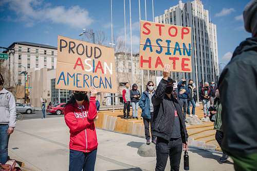 current events people walking on street during daytime hate crime